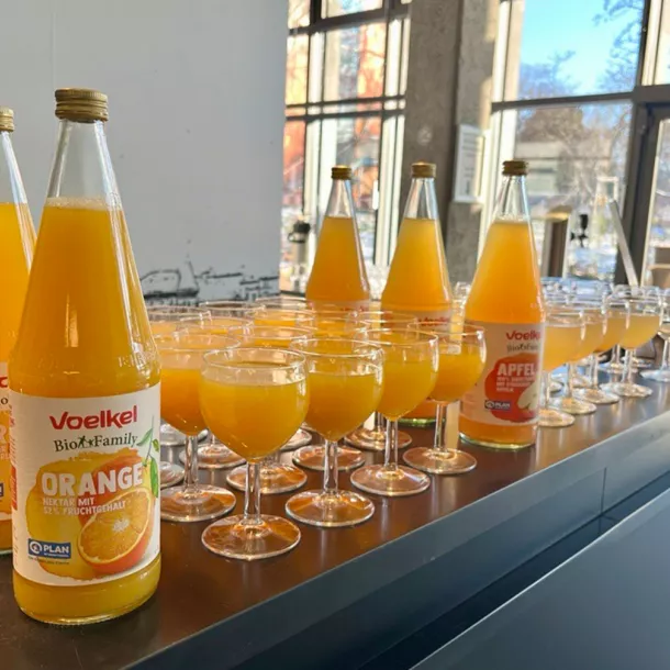 Orange juice bottles with glasses filled with it