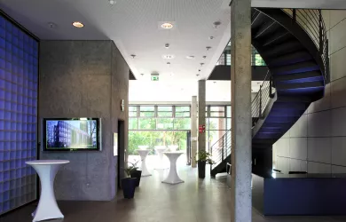 View into the foyer of the Umweltforum with stairs and elevator